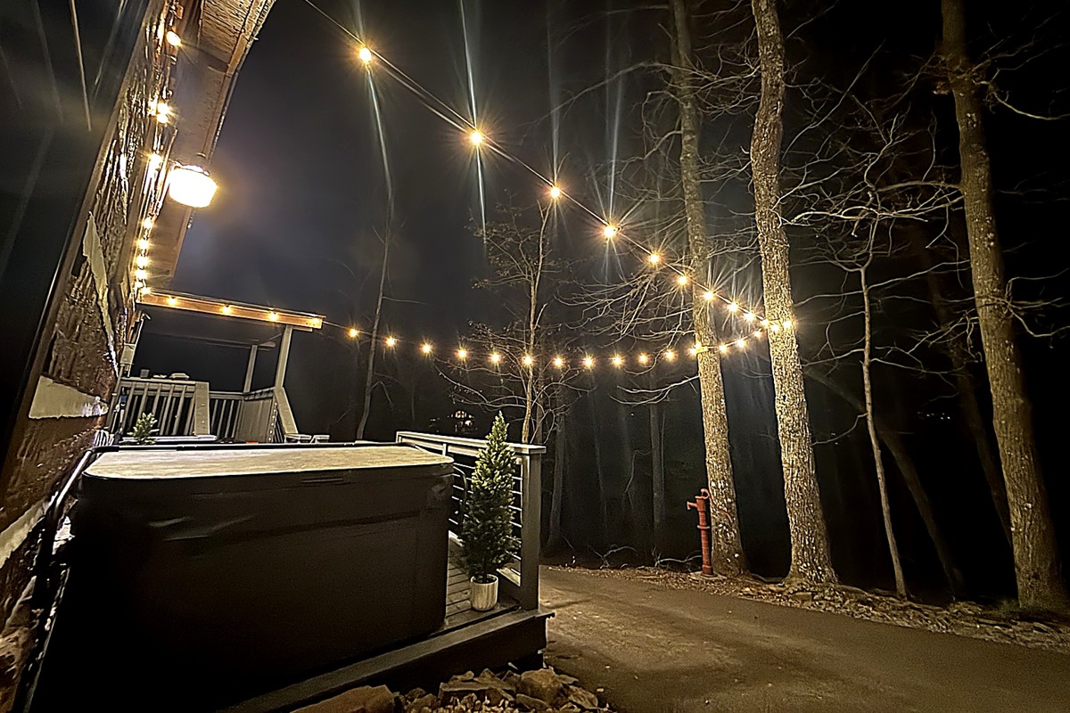 Private outdoor space nestled under warm string lights, offering peaceful mountain views duringbthe day…the perfect spot to relax and unwind.