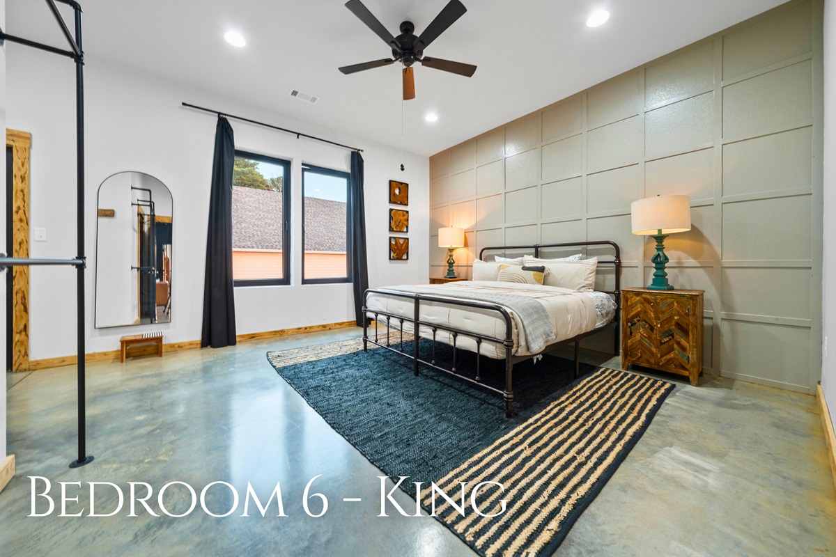 Bedroom 6 offers another inviting king bed in a bright, open space designed for relaxation.