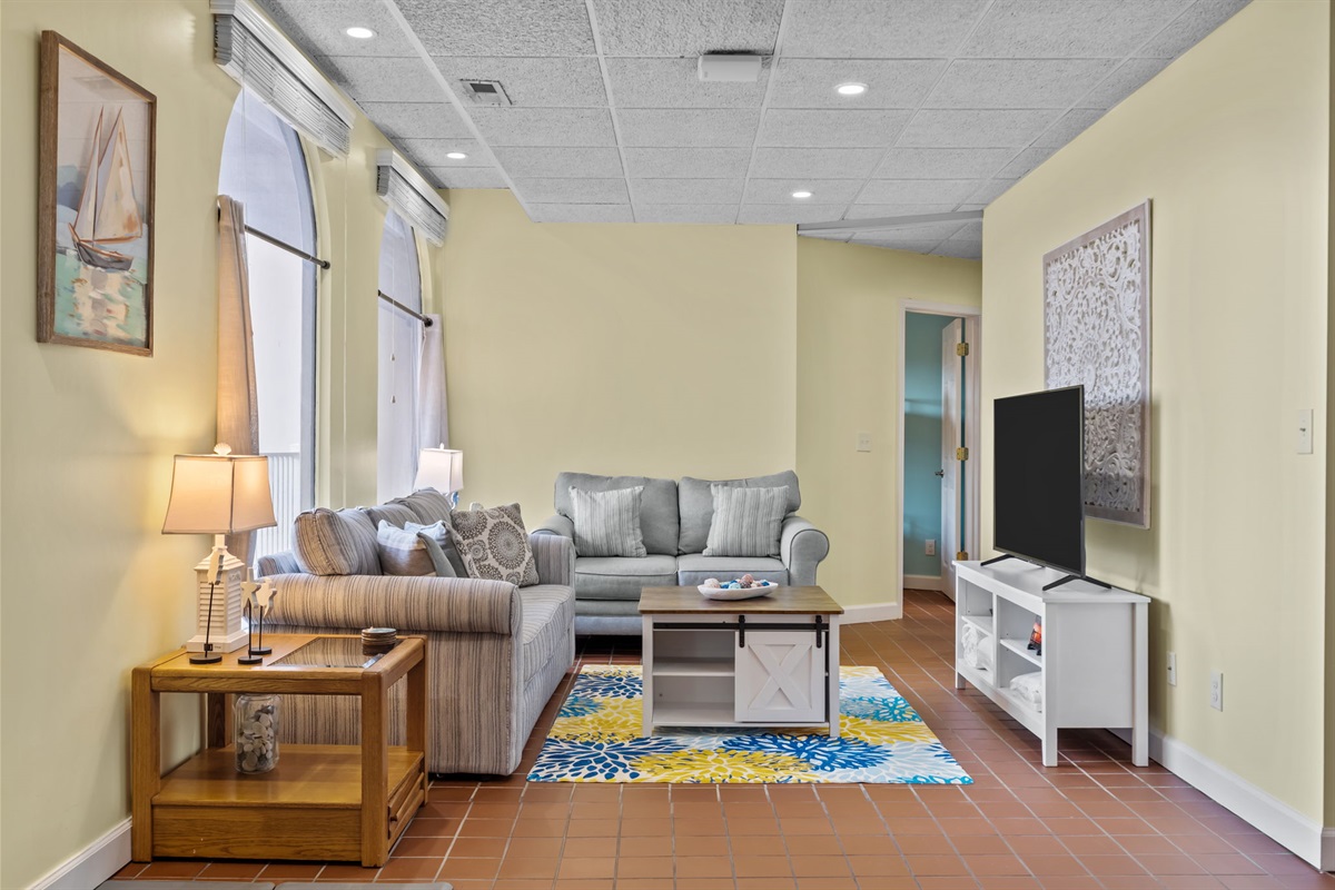Spacious, open-concept living area with wide pathways and comfortable seating&mdash;designed for easy movement, everyday comfort, and effortless lounging or movie nights