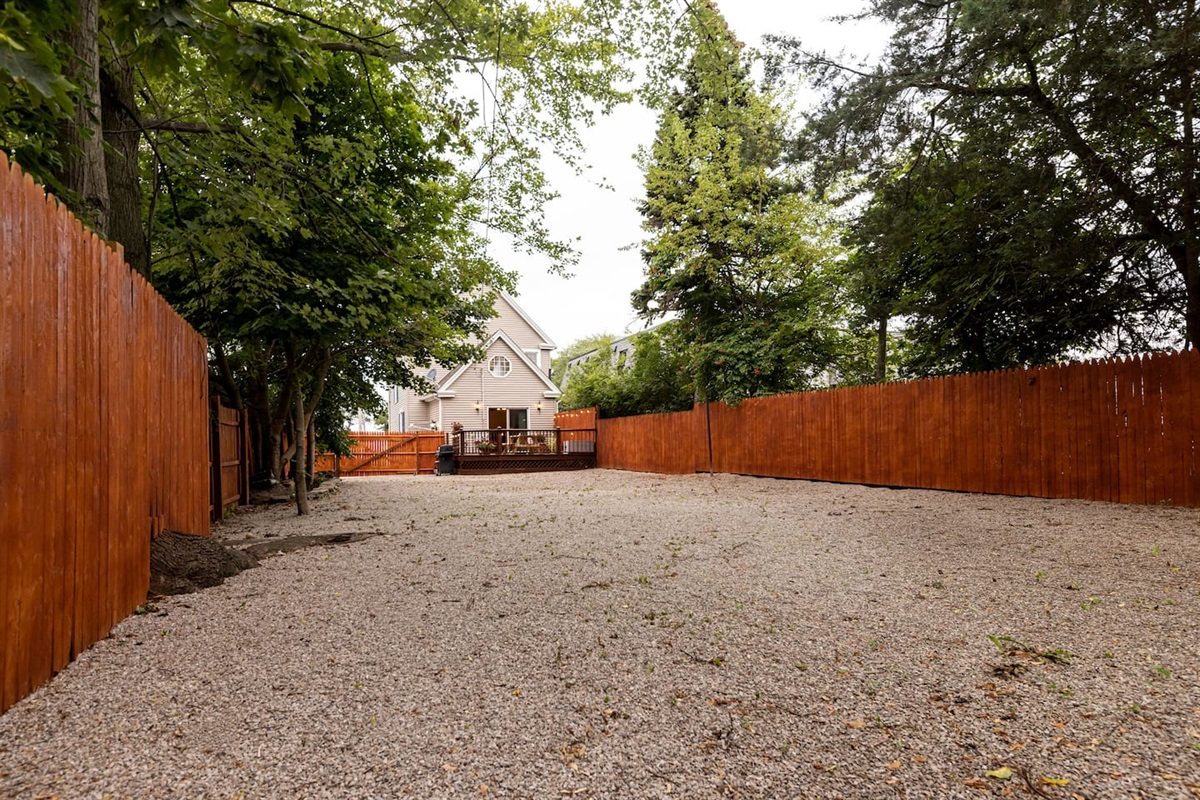 Nice big private back yard with a firepit & adirondack chairs to relax in.