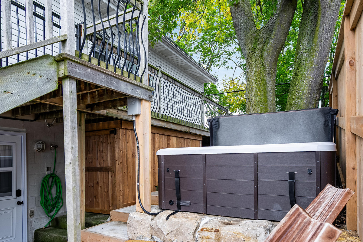 Serene backyard retreat featuring a private hot tub and elevated deck.