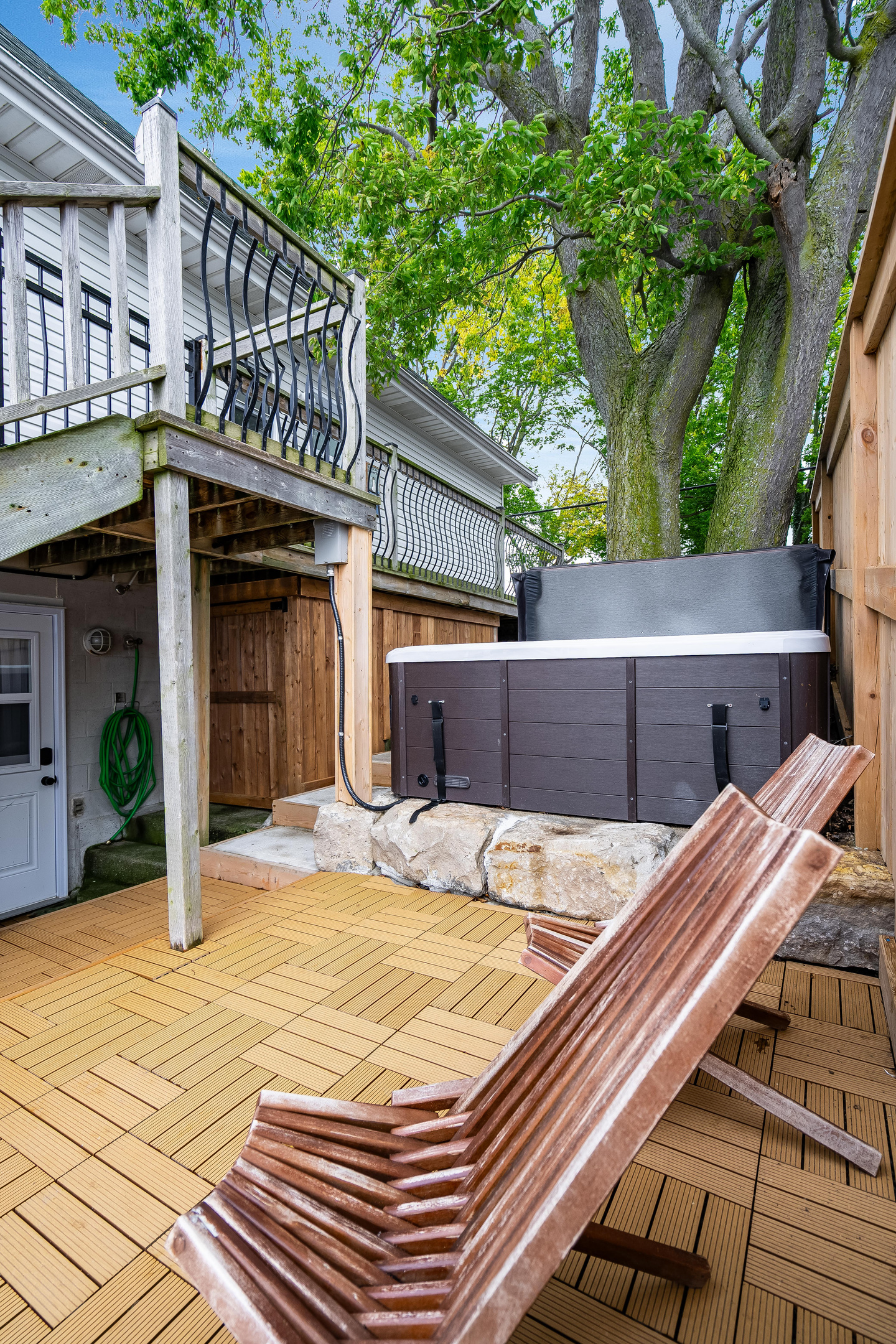 Serene backyard retreat featuring a private hot tub and elevated deck.