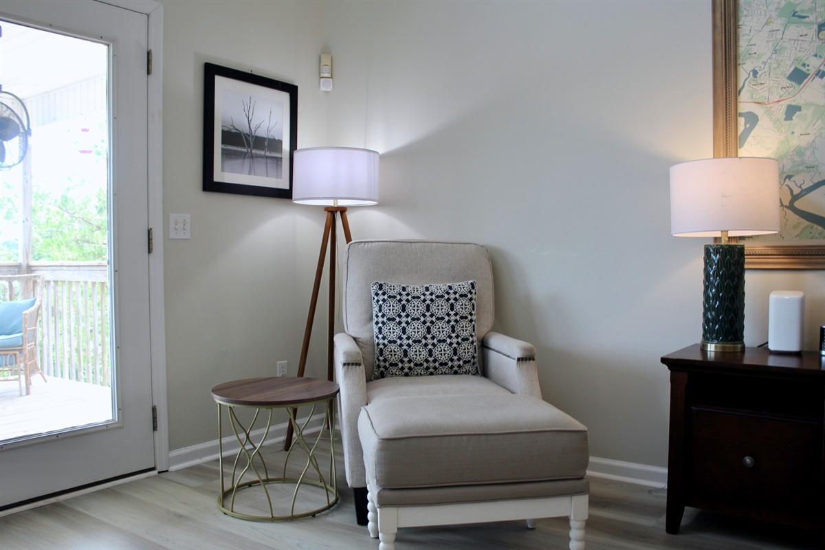 Unwind with a good book or morning coffee in this cozy corner by the deck.