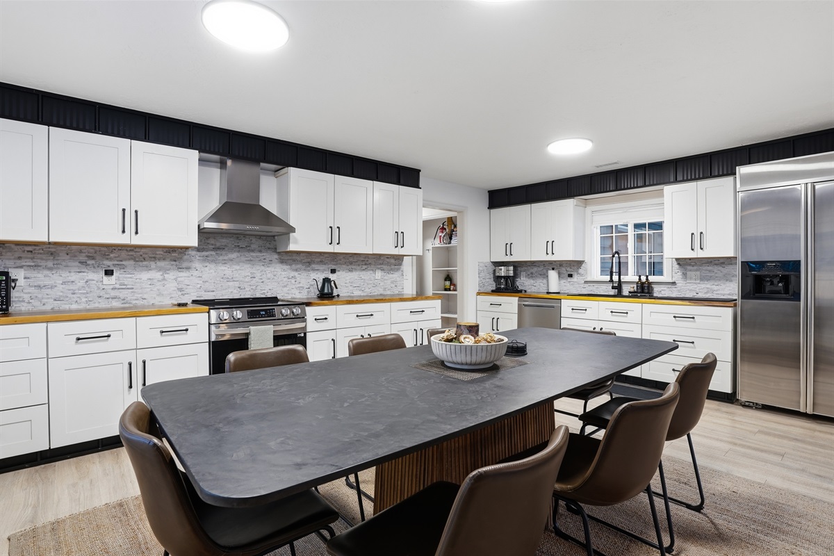 Pristine kitchen and spacious dining for groups.