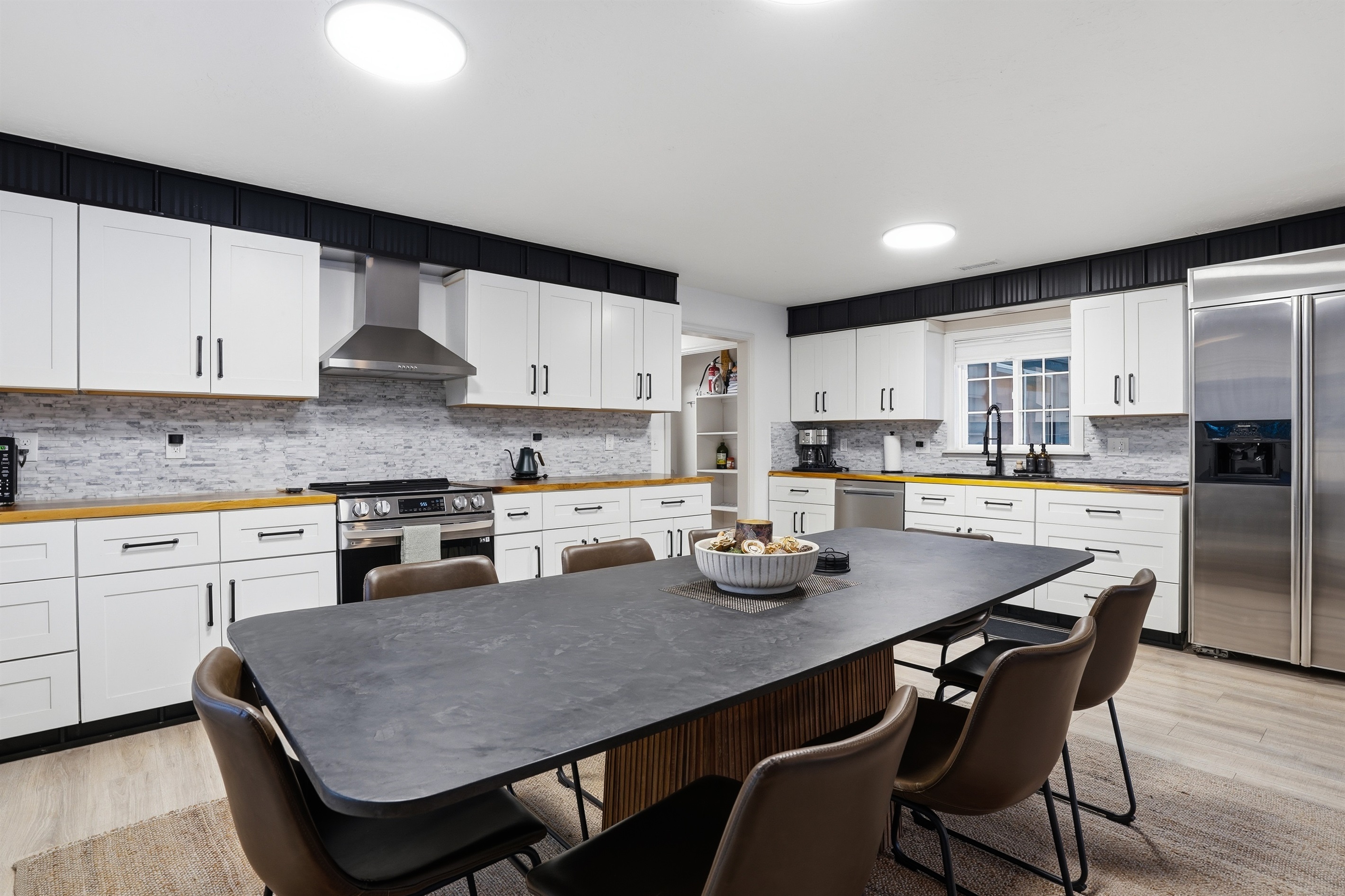 Pristine kitchen and spacious dining for groups.