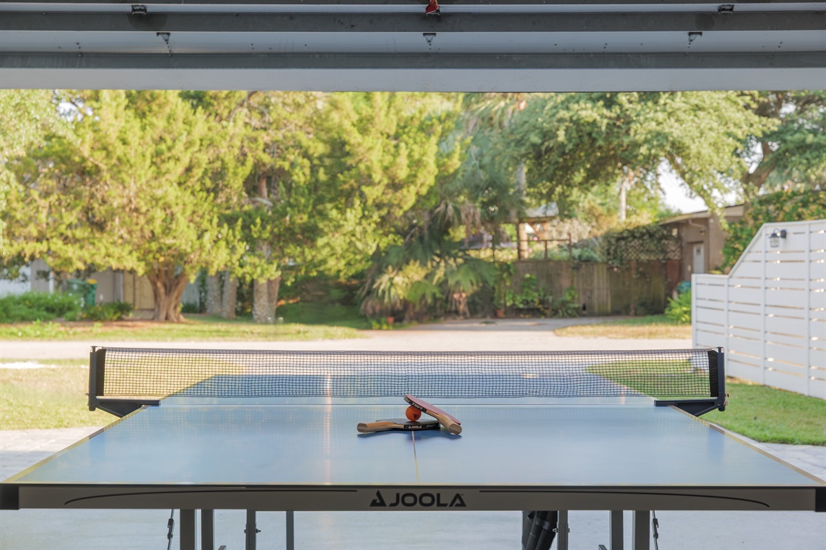 Open-air garage game room with ping pong table