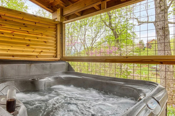 Enjoy a warm soak in the private hot tub while you listen to the breeze move through the trees