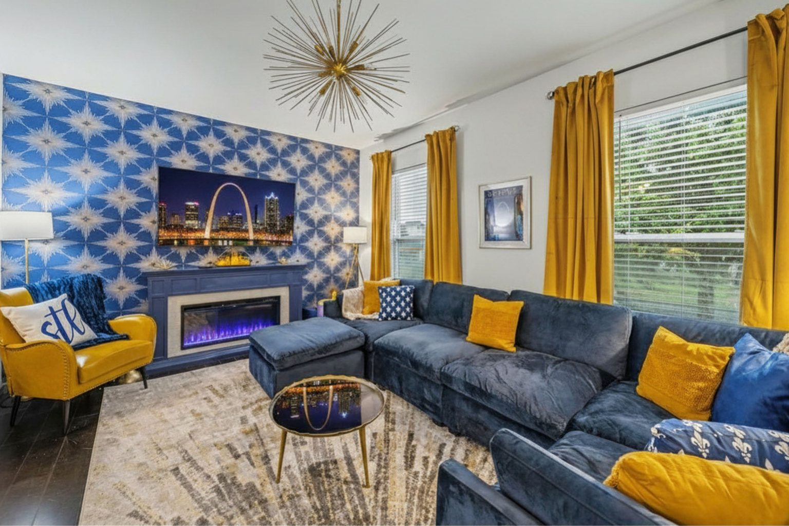 Gather in the Legends Lounge featuring a designer sectional, fireplace, record player, and St. Louis-inspired decor.
