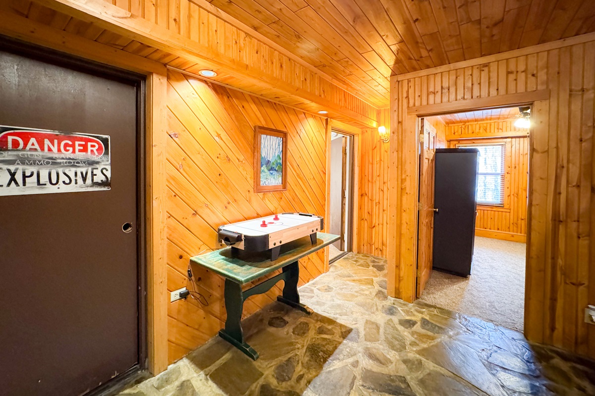 lower level foyer area. complete with tabletop Air hockey and dart board. There is a washer and dryer in the old ammo room - now labeled "Danger Explosives".
