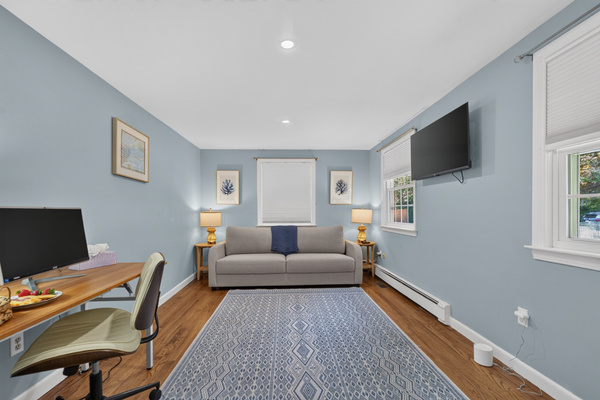 Comfortable bedroom with dedicated workspace for work or study.