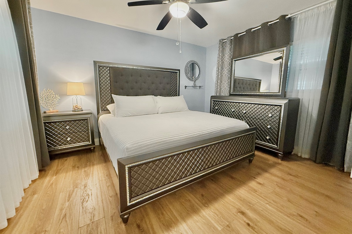 Retreat to a stunning master bedroom featuring a king bed, designer furniture, and calming ambiance—perfect for unwinding in style.