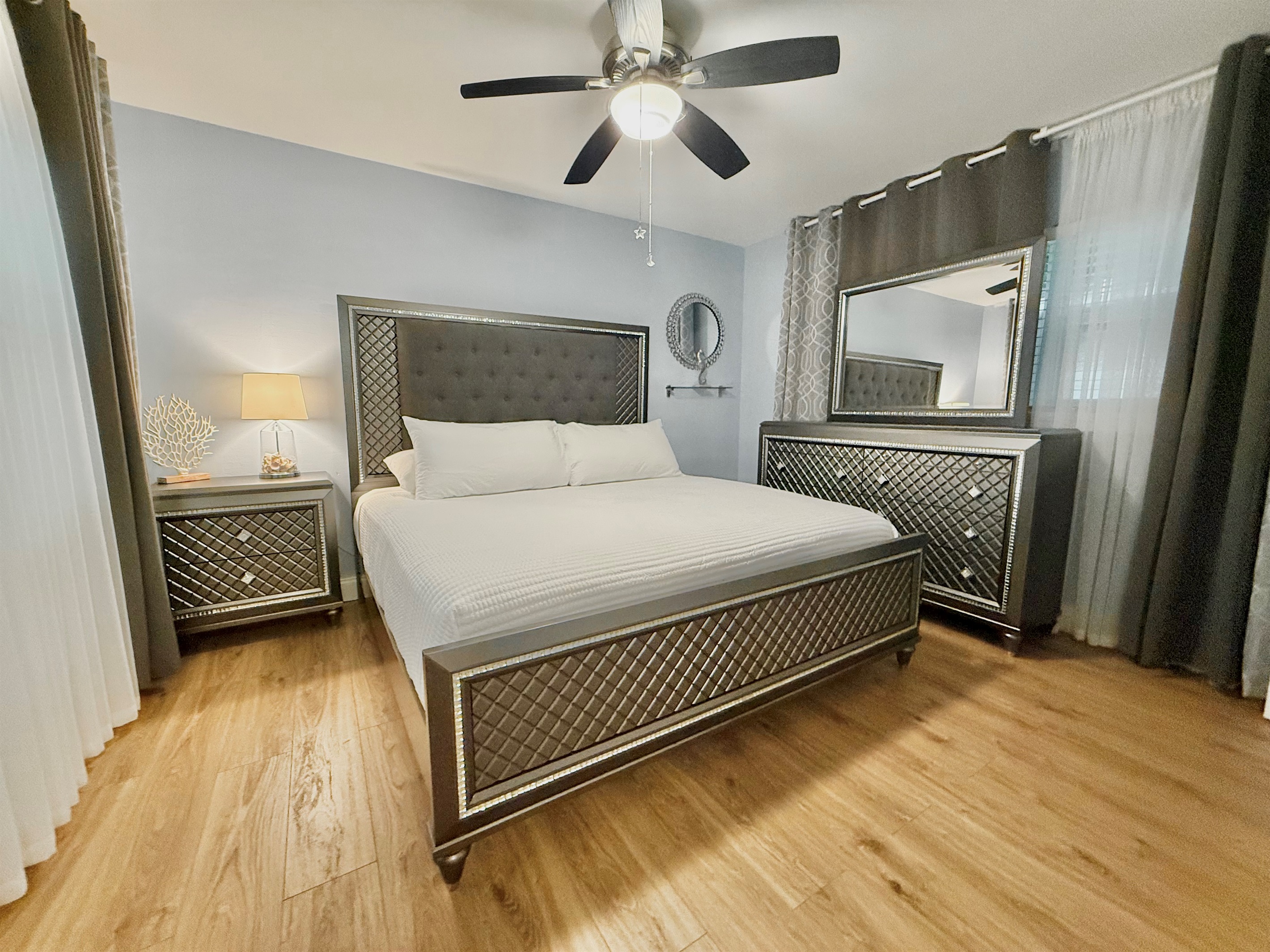 Retreat to a stunning master bedroom featuring a king bed, designer furniture, and calming ambiance—perfect for unwinding in style.
