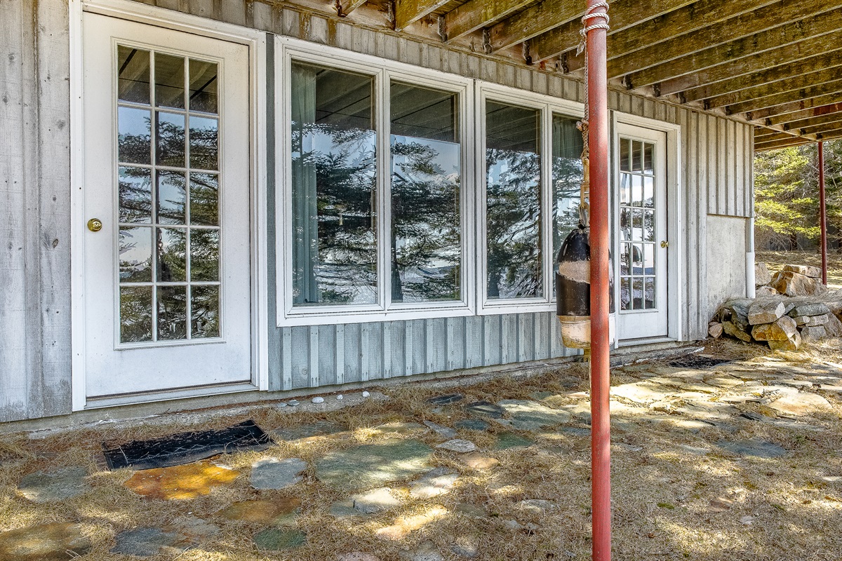 "A Seamless Transition."
Looking back from the top of the beach stairs toward the lower-level patio and entertainment room. This secondary entrance allows for effortless indoor-outdoor living, perfect for coming and going from the shore.