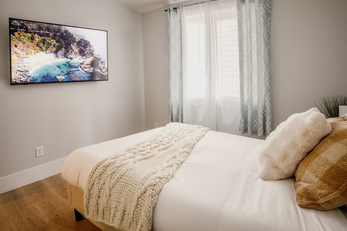 Queen bedroom with a 55-inch 4K smart TV. Lay down, watch your favorite show, drift off, and wake up refreshed for another day of adventure.