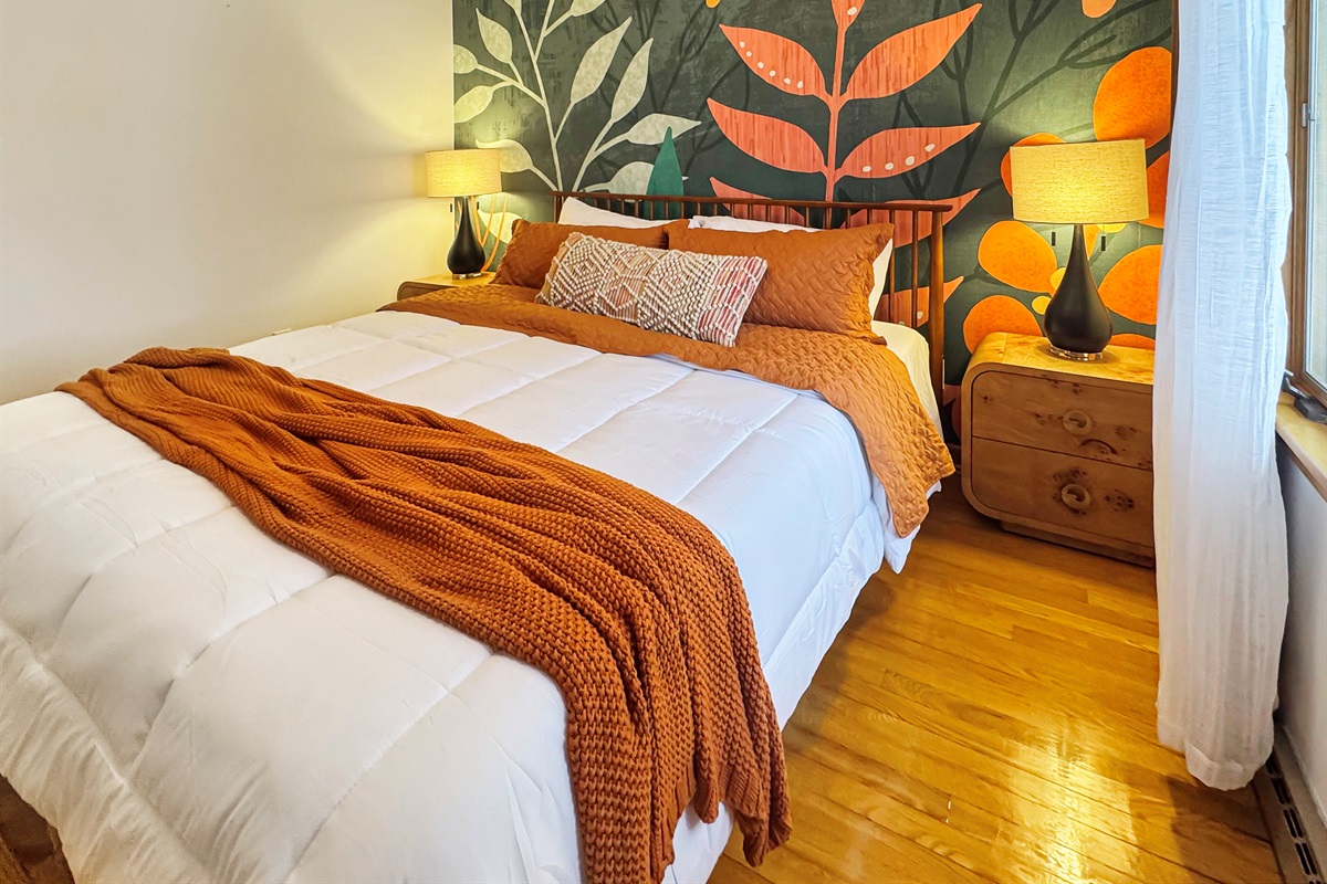 King bed with luxury linens and a stunning full wall mural as your backdrop.