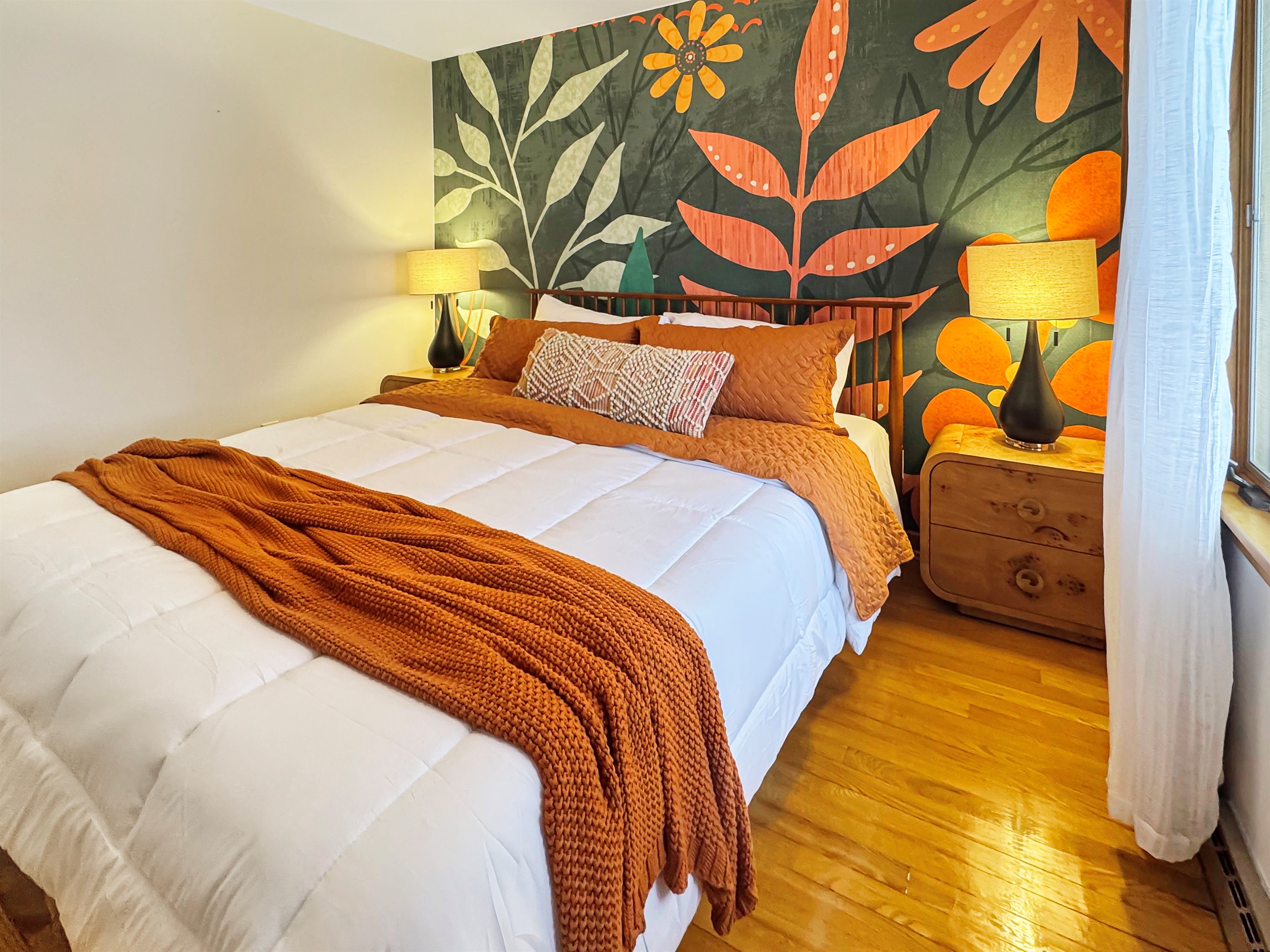 King bed with luxury linens and a stunning full wall mural as your backdrop.