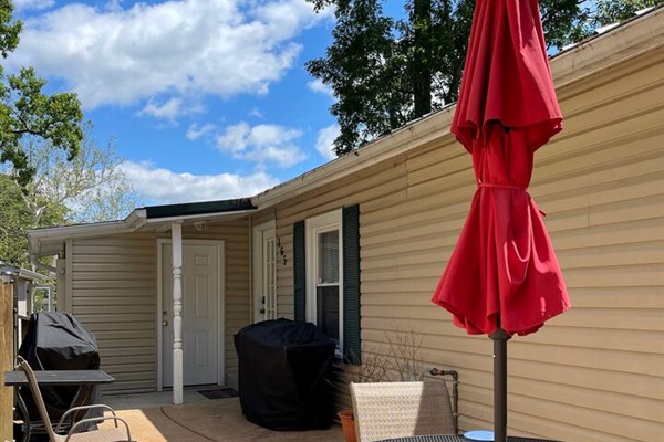 Concrete patio area with a BBQ grill and a Blackstone Griddle Grill. Smoking/Vaping area outside only. 