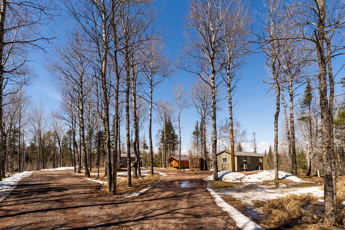 Driveway view from left to right: Outhouse, Pine Cabin, Sauna, Ridge Cabin