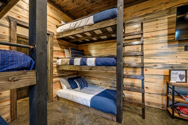 Custom-built bunk beds in a modern, wood-clad forest retreat.