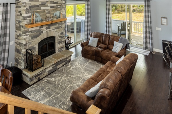 Cozy living room with a wood burning fireplace and stunning view of mountains