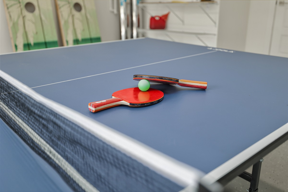 Ping pong and corn hole provided for outdoor fun