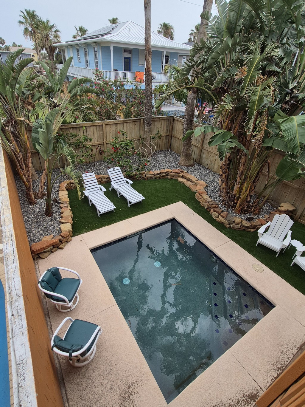 Unwind in our tropical backyard featuring thoughtfully designed landscaping, sparkling dipping pool, and lounge seating.
