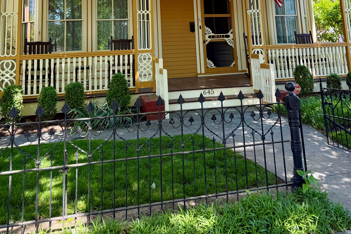 fenced yard is another rare amenity, and the wrought iron is a beautiful detail