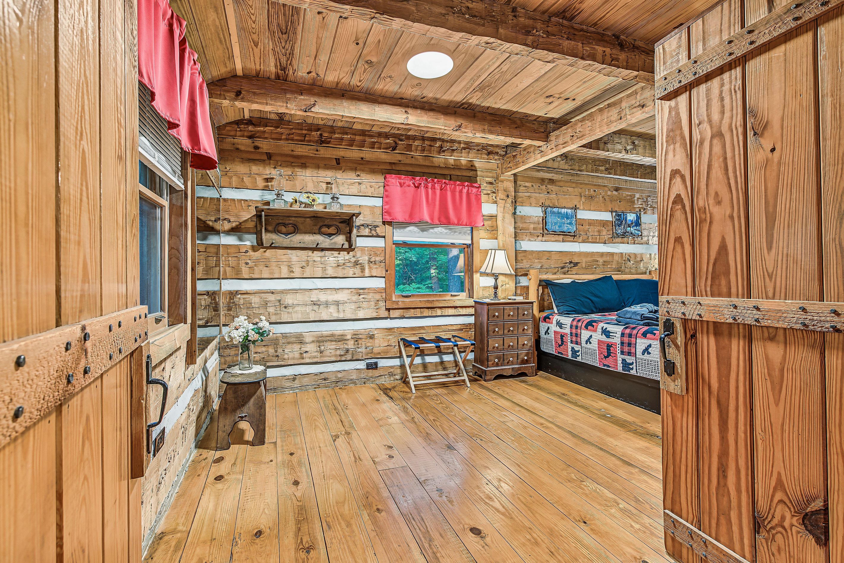Step into the rustic bedroom with wood walls and a peaceful cabin feel.