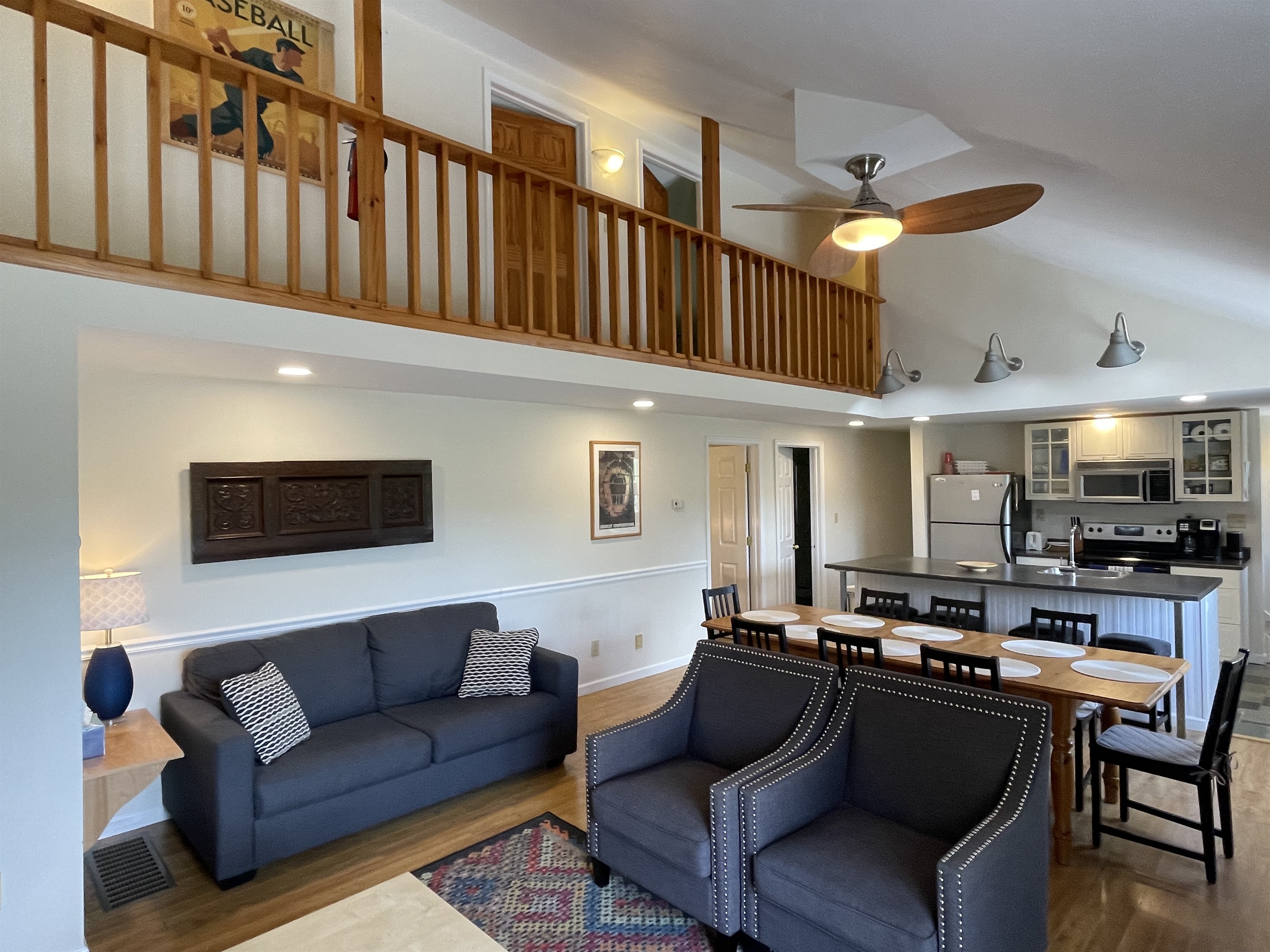 Open concept living area with vaulted ceiling