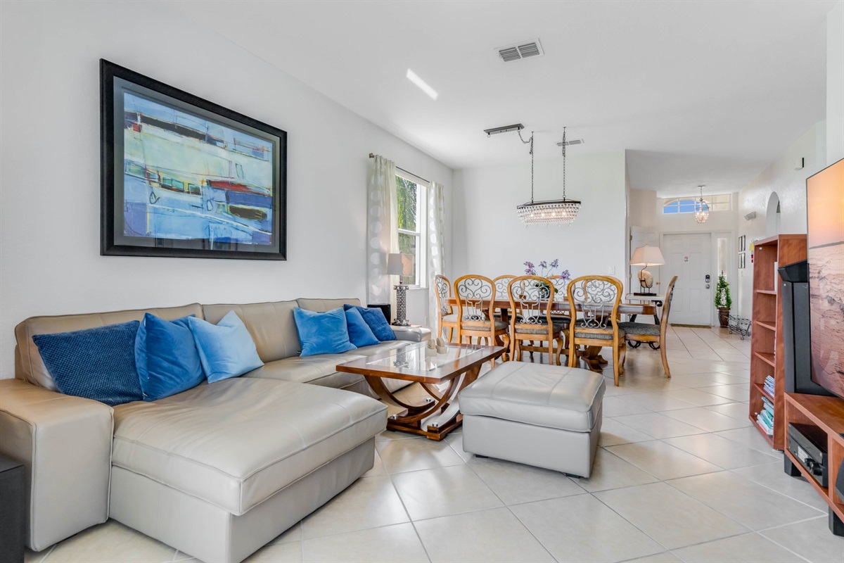 The theater room is open to the dinig area behind.