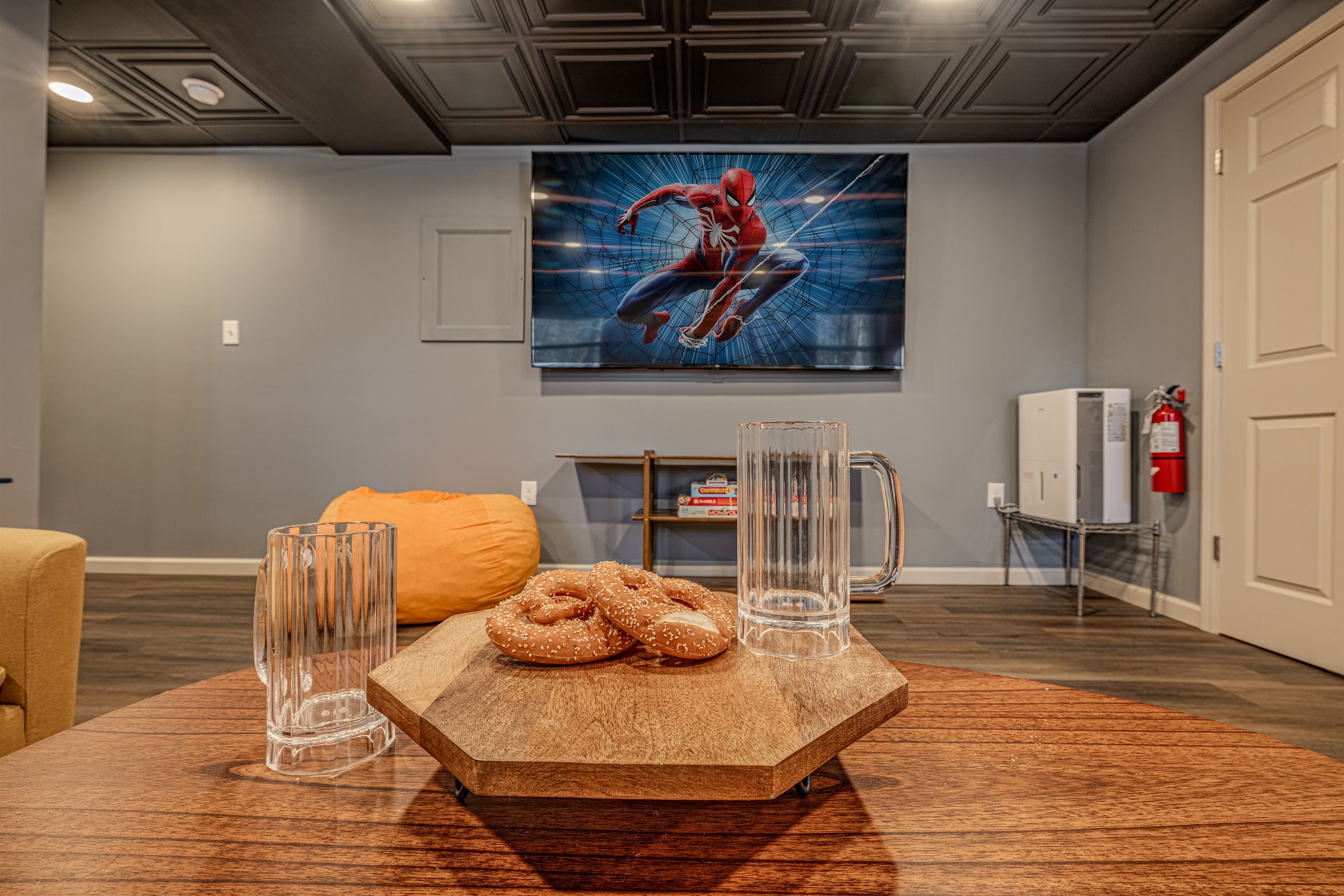 Stream your favorite films or games on the large wall-mounted smart television in this modern, spacious entertainment lounge.