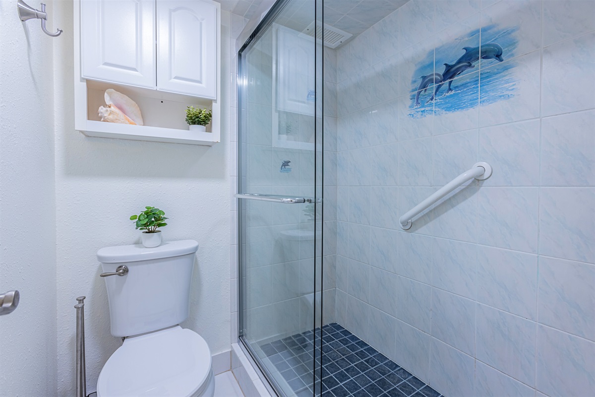 Tiled Shower with Glass Doors and Grab Bars