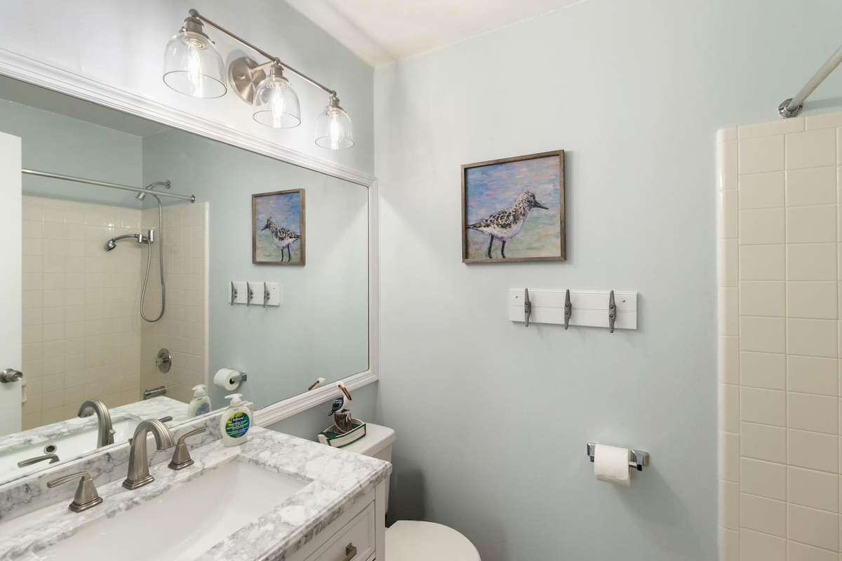Head into your private bath off Queen Suite Two &mdash; clean, bright, and all yours for the stay.
