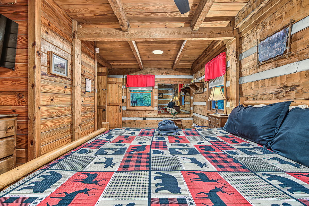 Relax into the inviting bedroom with rustic wood details and a comfy bed.