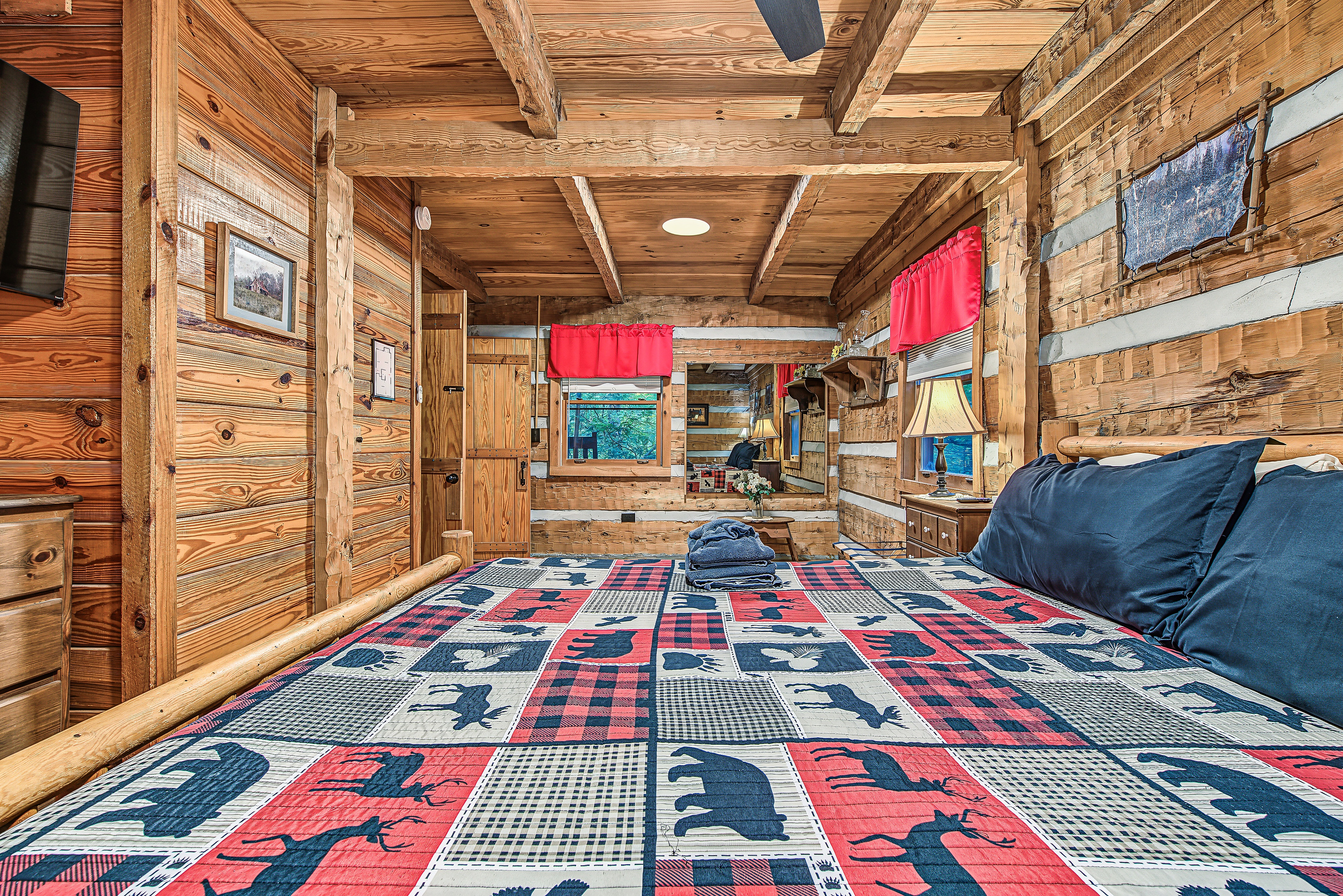 Relax into the inviting bedroom with rustic wood details and a comfy bed.