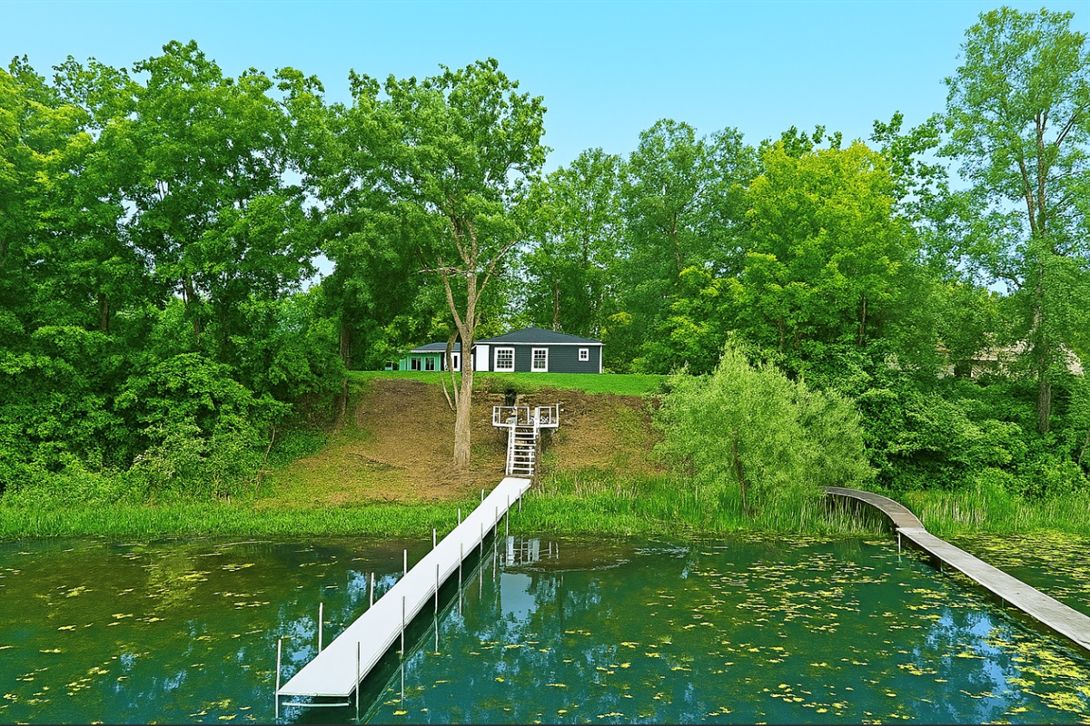 Private dock leads right to your lakeside retreat—seamless access for paddling or relaxing in the view.