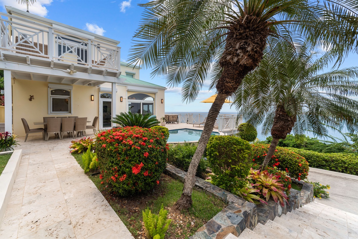 Open-air space with pool views and casual seating, hang out, catch a breeze, or toast to vacation mode.