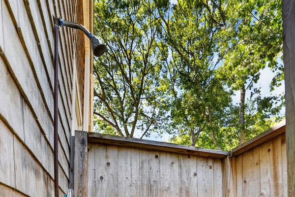 Enclosed outdoor shower, perfect for washing away sand before heading inside.