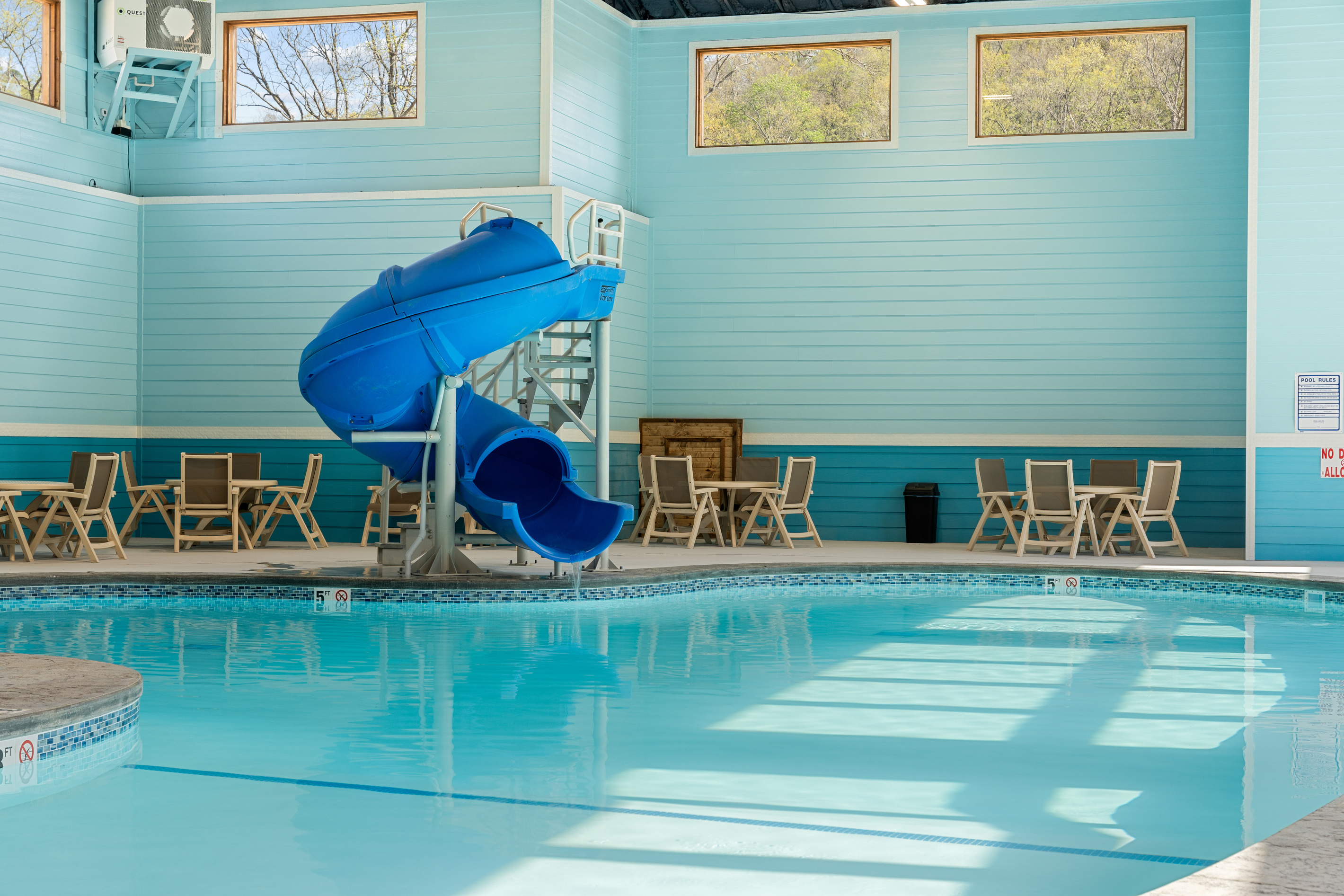 Splash down the indoor pool waterslide in any season,  a year-round family favorite at Tall Timbers Camp.