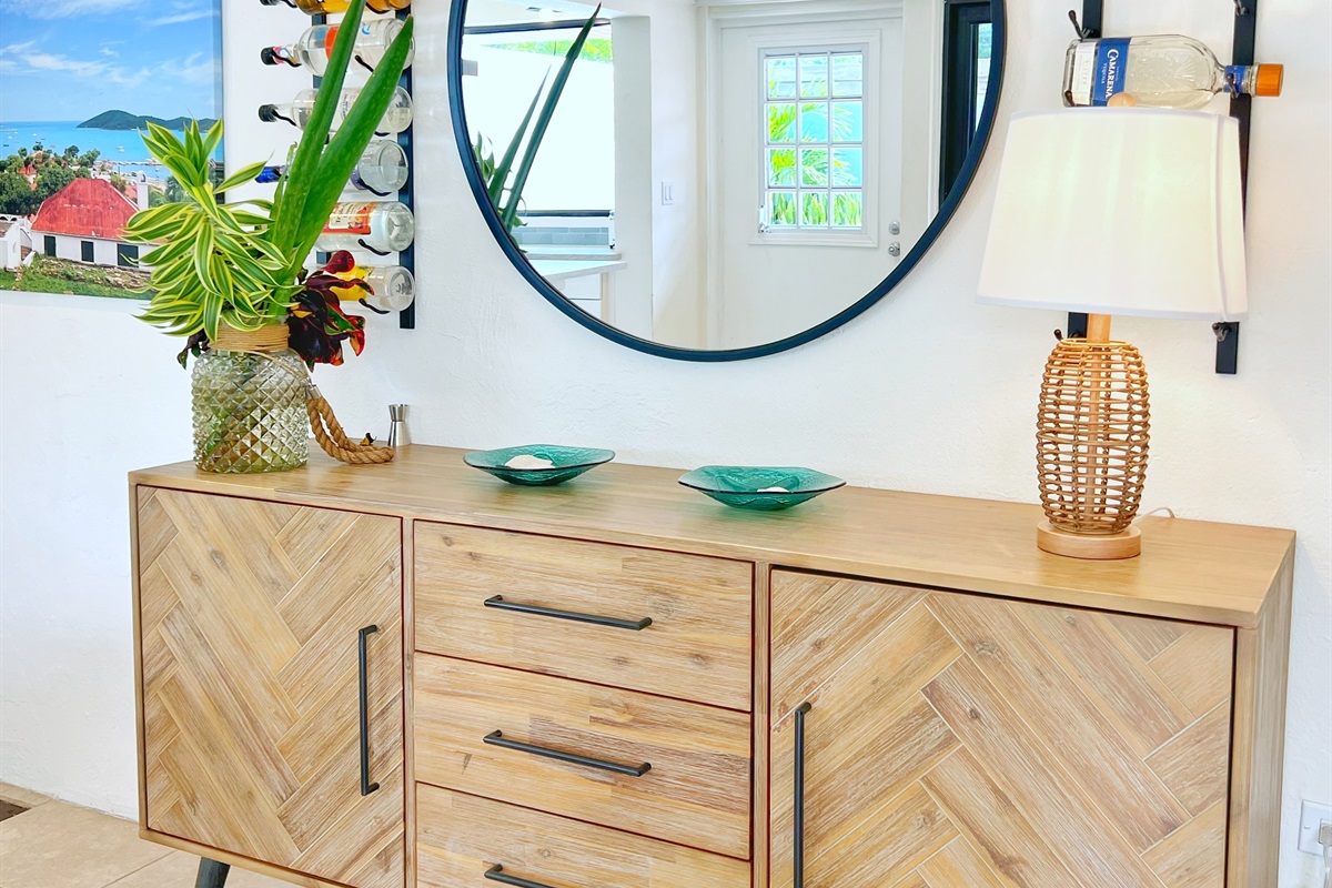 Wall-mounted mirrors and chest drawers add style and practicality.