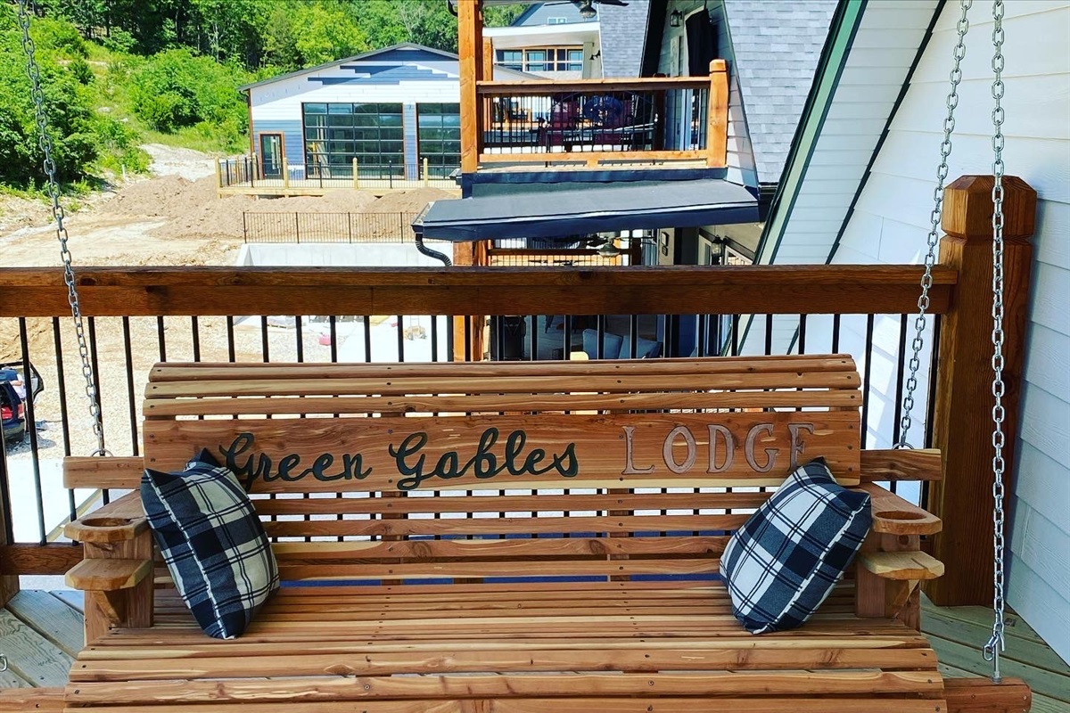 Private deck with custom cedar swing accessed through Bright River room.