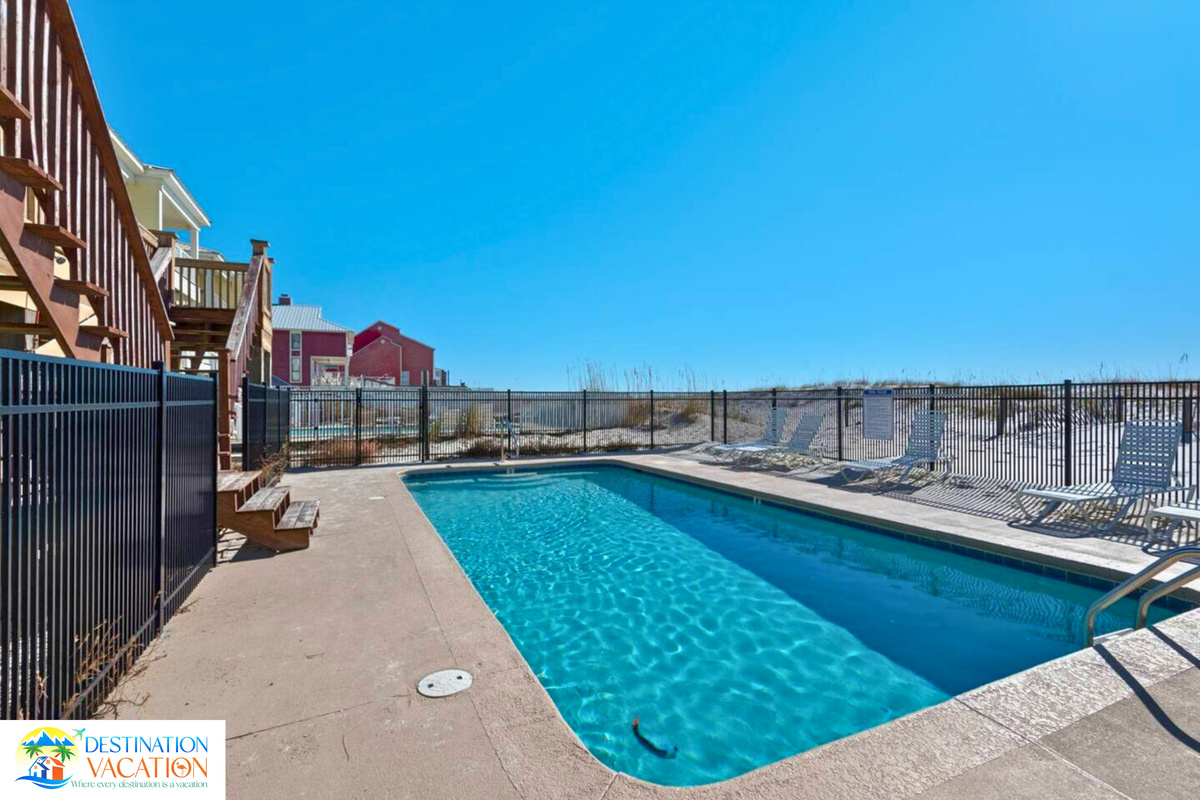 Relax poolside with the beach stretching beyond.