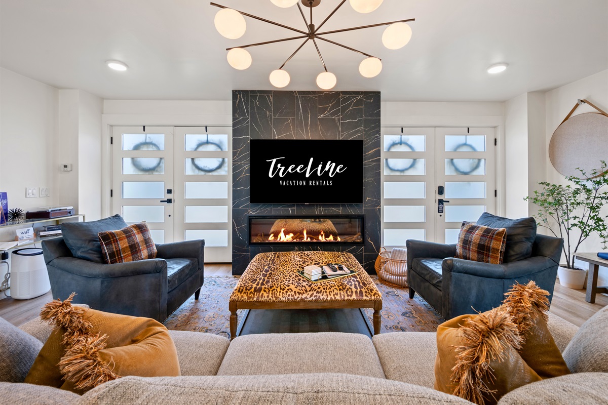 With a fireplace as the focal point, this living space feels both stylish and welcoming, making it the perfect place to curl up after a day spent exploring outdoors.