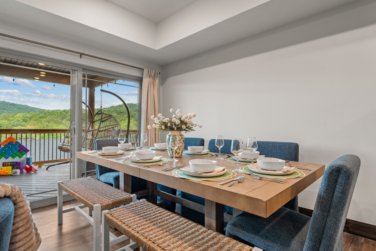 Table set and deck doors open, with giant building blocks on the balcony to keep the kids busy.