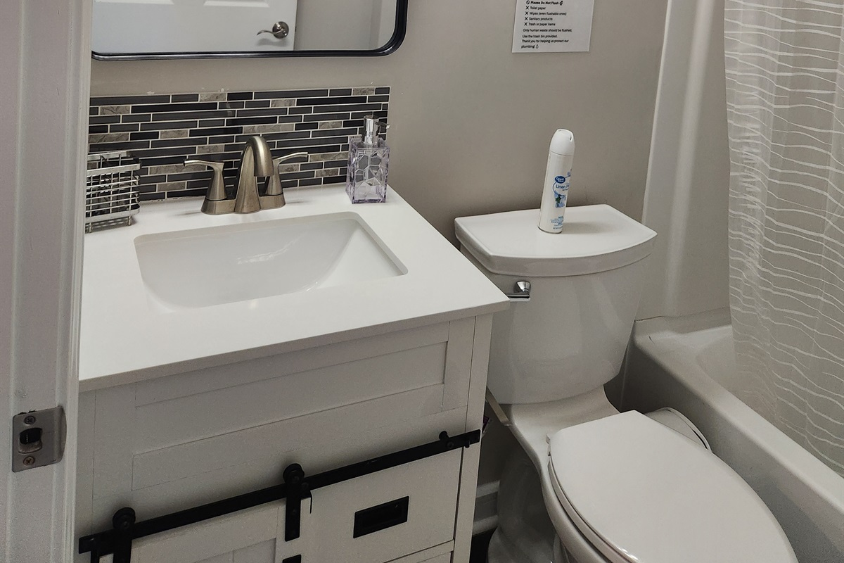 This bathroom blends modern design with cozy touches.