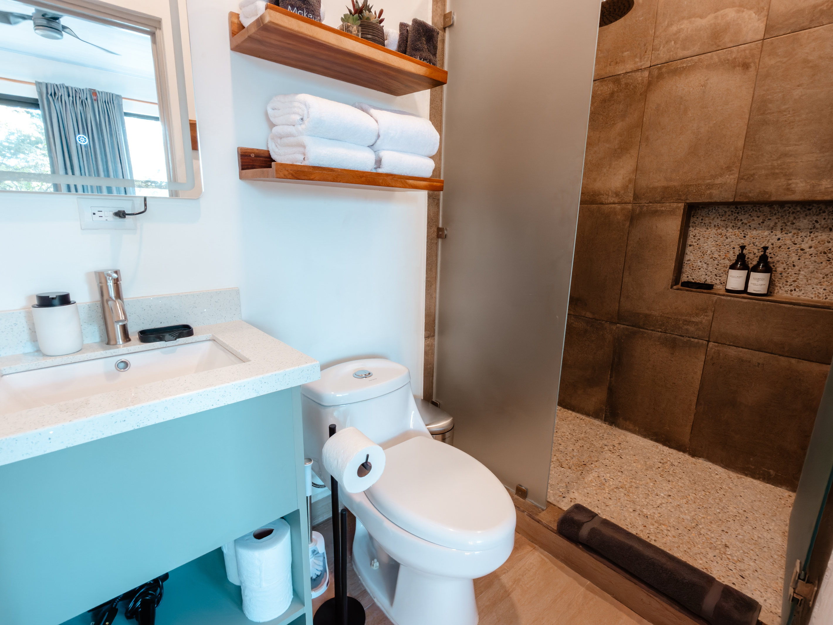 Identical to Bathroom 1. Rain shower, frosted glass, LED mirror.