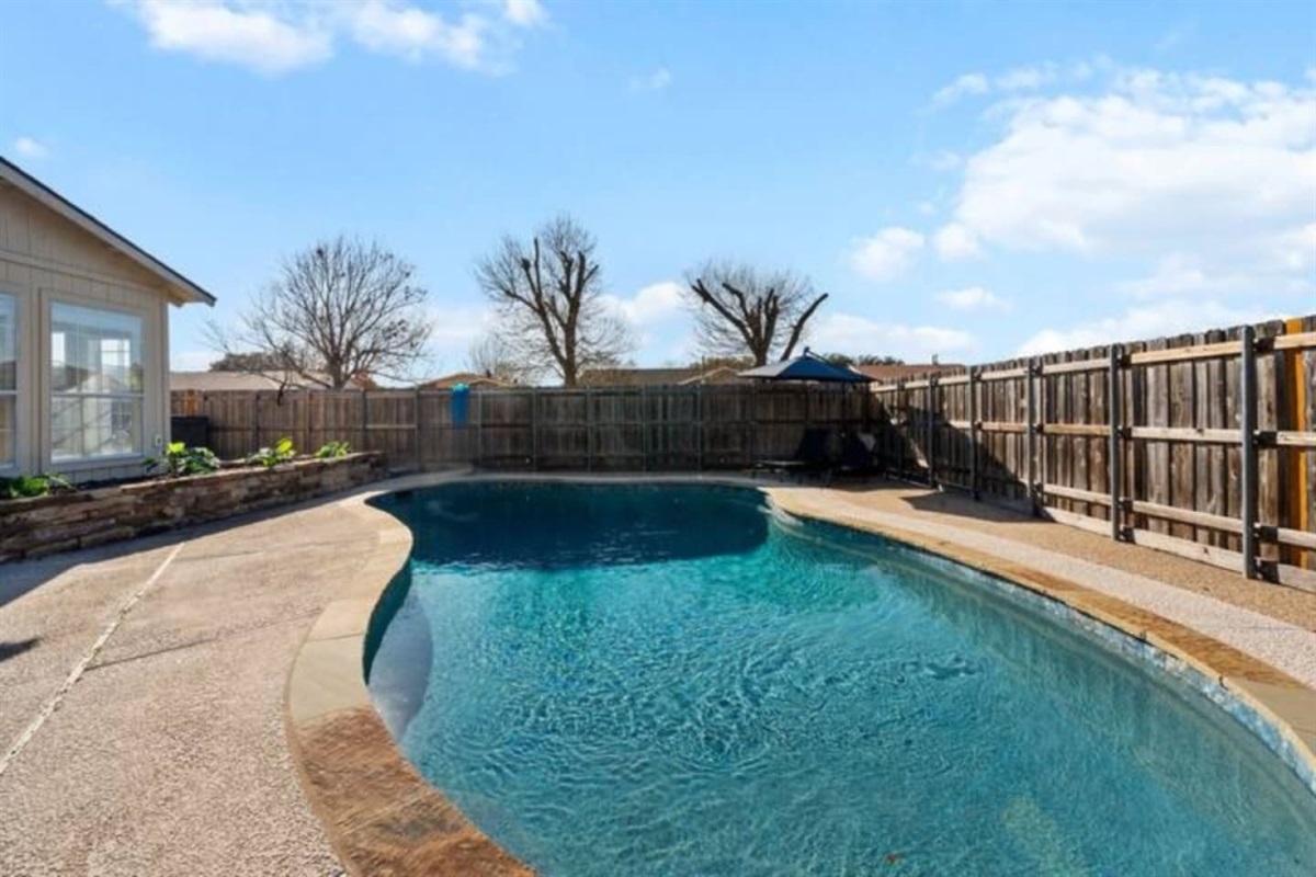 Private backyard oasis with sparkling pool, sun loungers, and direct access to the indoor bar—perfect for poolside entertaining.