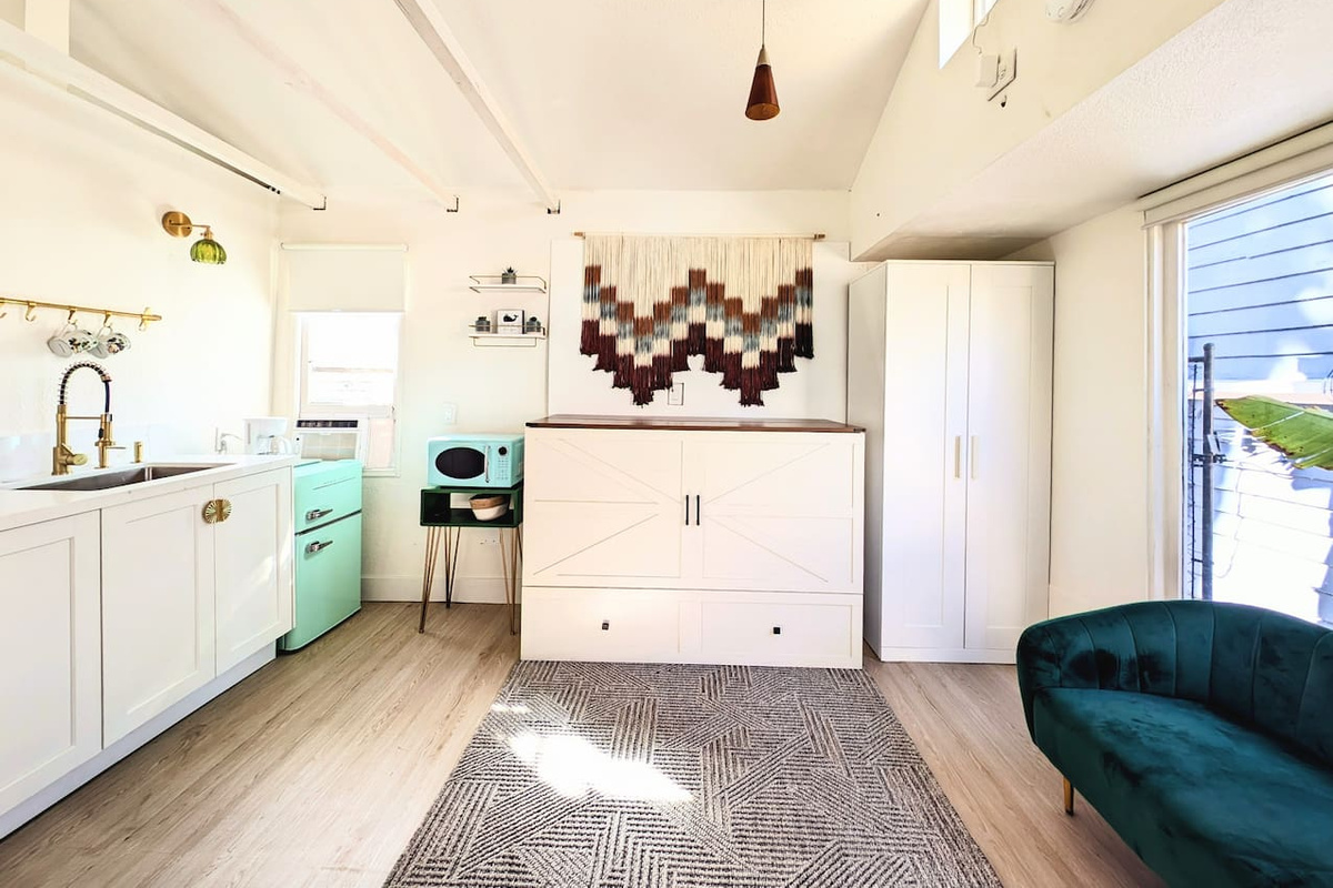 Queen Murphy bed folds away to maximize space.