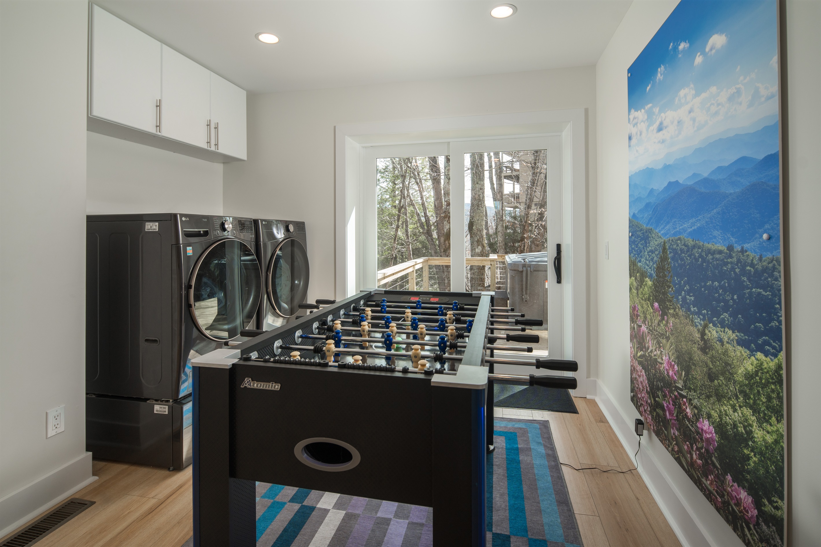 Between the kitchen and Spring Flowers Bedroom, you can enjoy a fun game of foosball! The laundry is located in the game area, along with access to the side deck/hot tub.