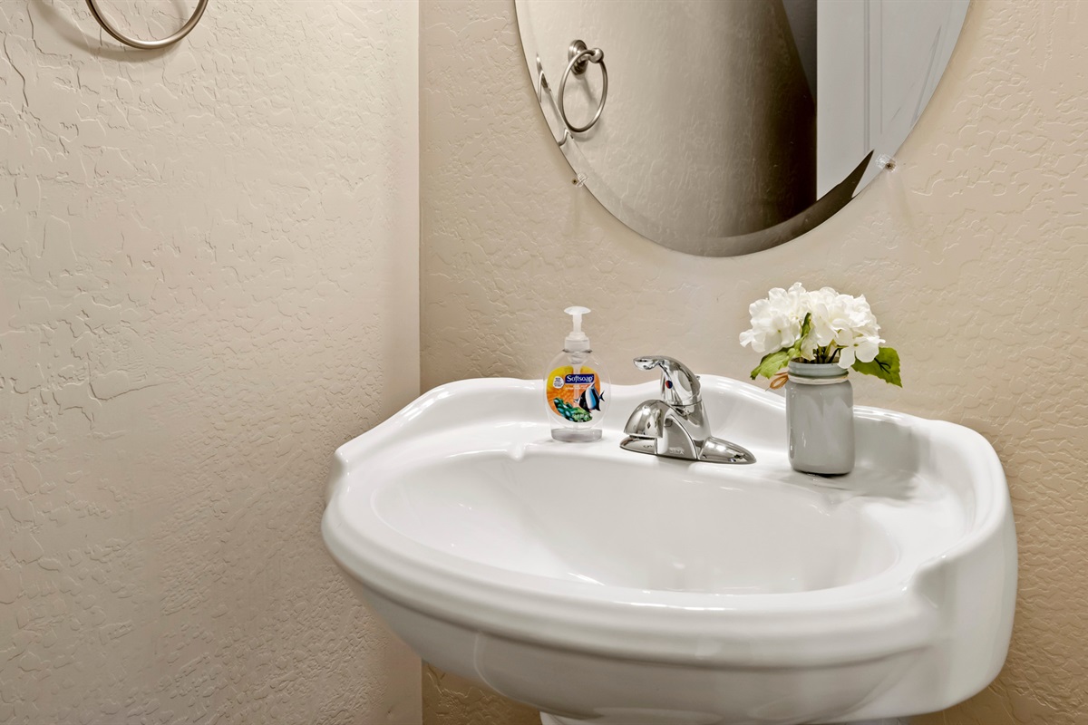 Convenient guest bathroom is tucked away under the stairs, easily accessible from the living room for your comfort.